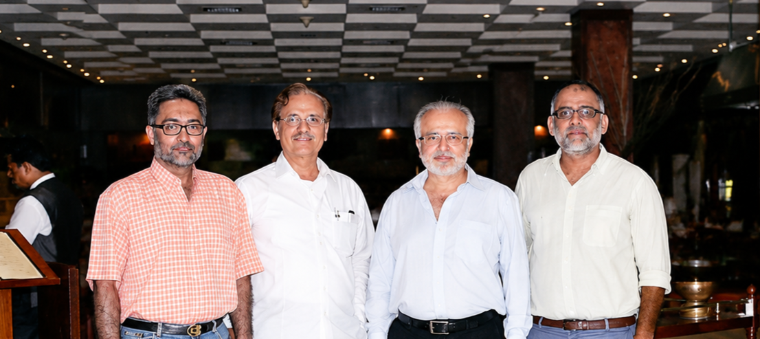 Six WTAP members standing together in a hotel lobby before a meeting