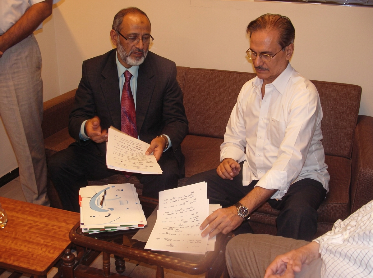 Two WTAP members reviewing trade papers during a working session